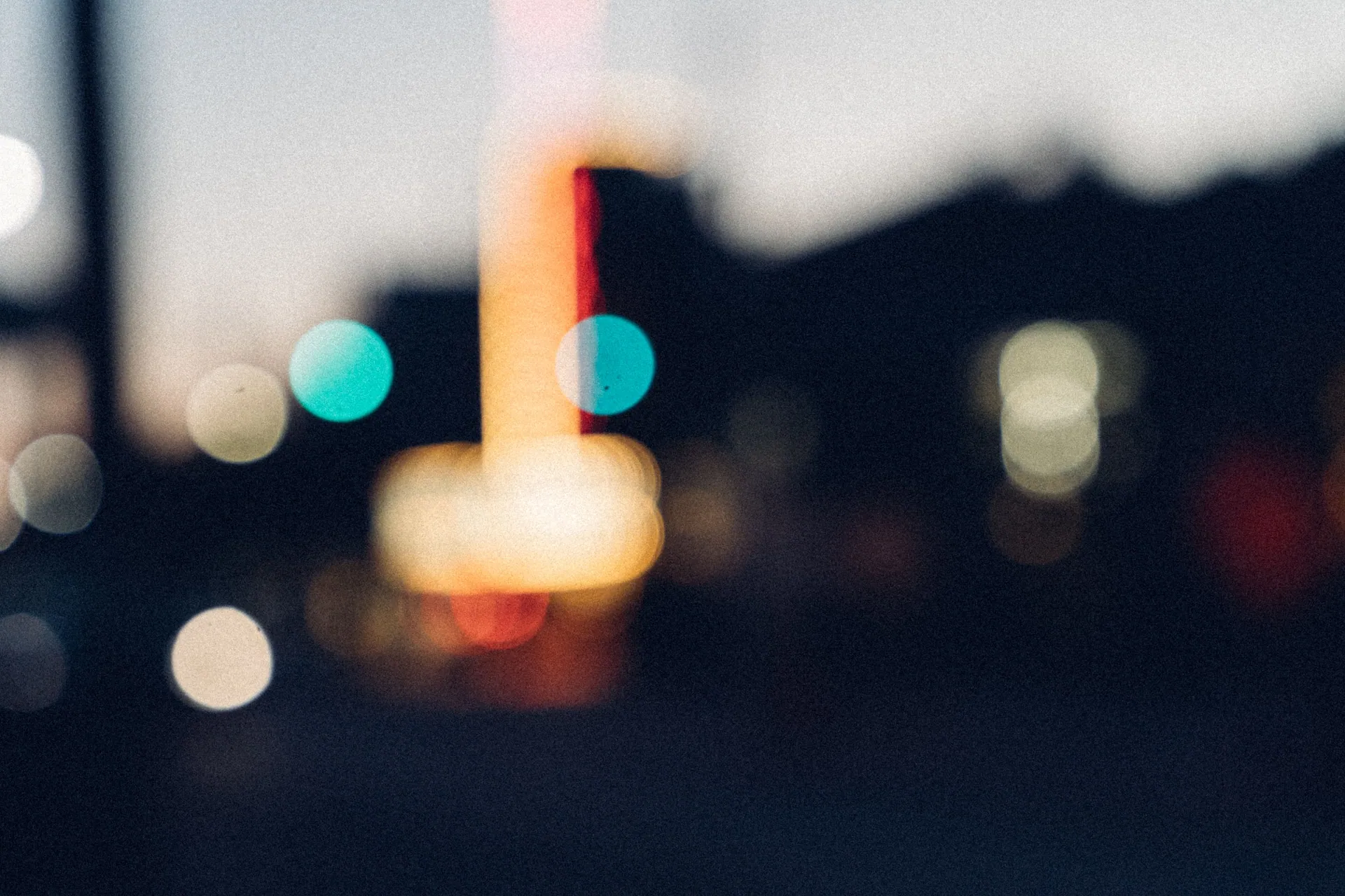 Blurred city night lights with bokeh effect creating a dreamy ambiance.