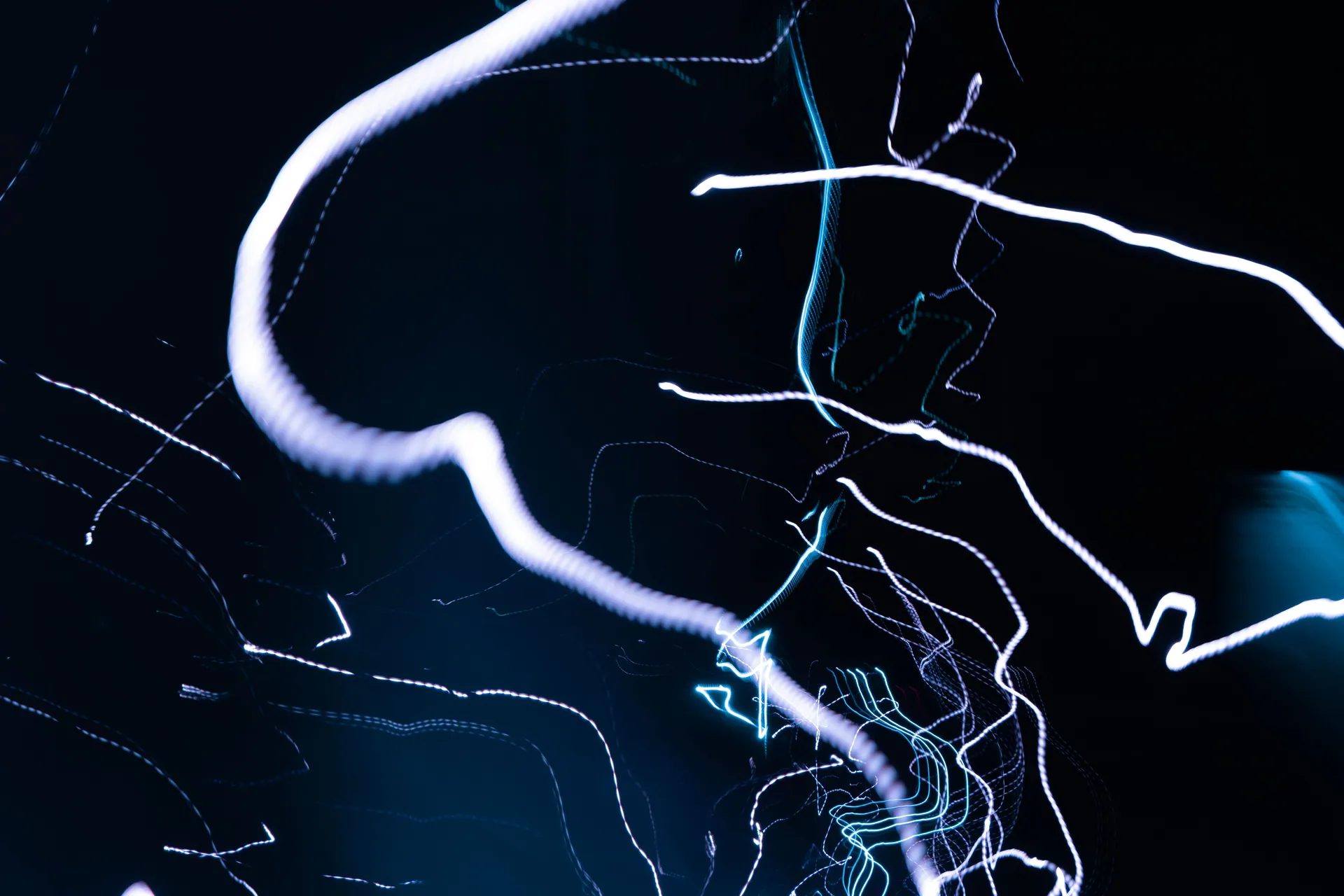 Captivating abstract image featuring vibrant light trails on a dark background.