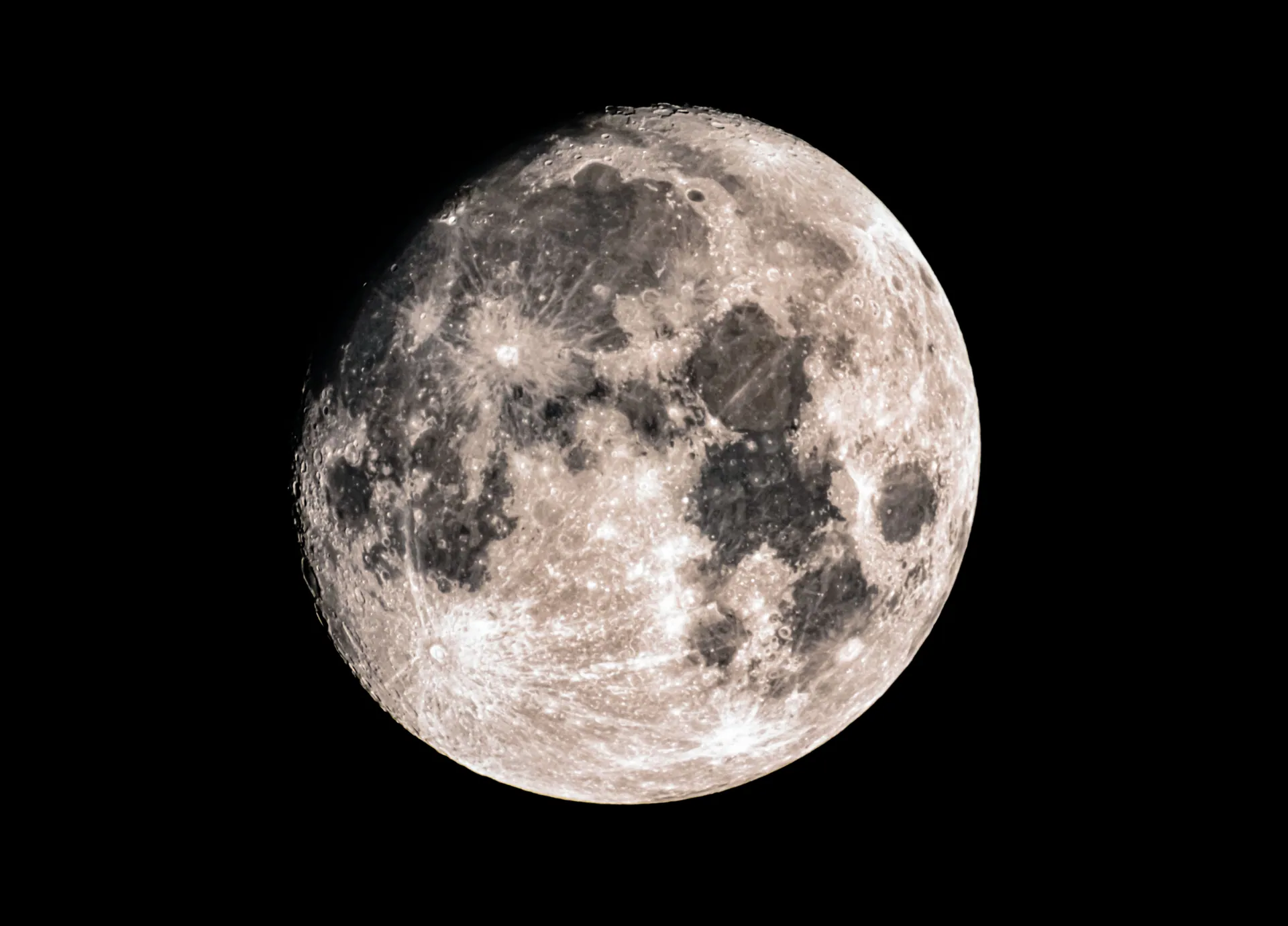 Detailed close-up of a full moon with visible craters and surface texture against a black background.