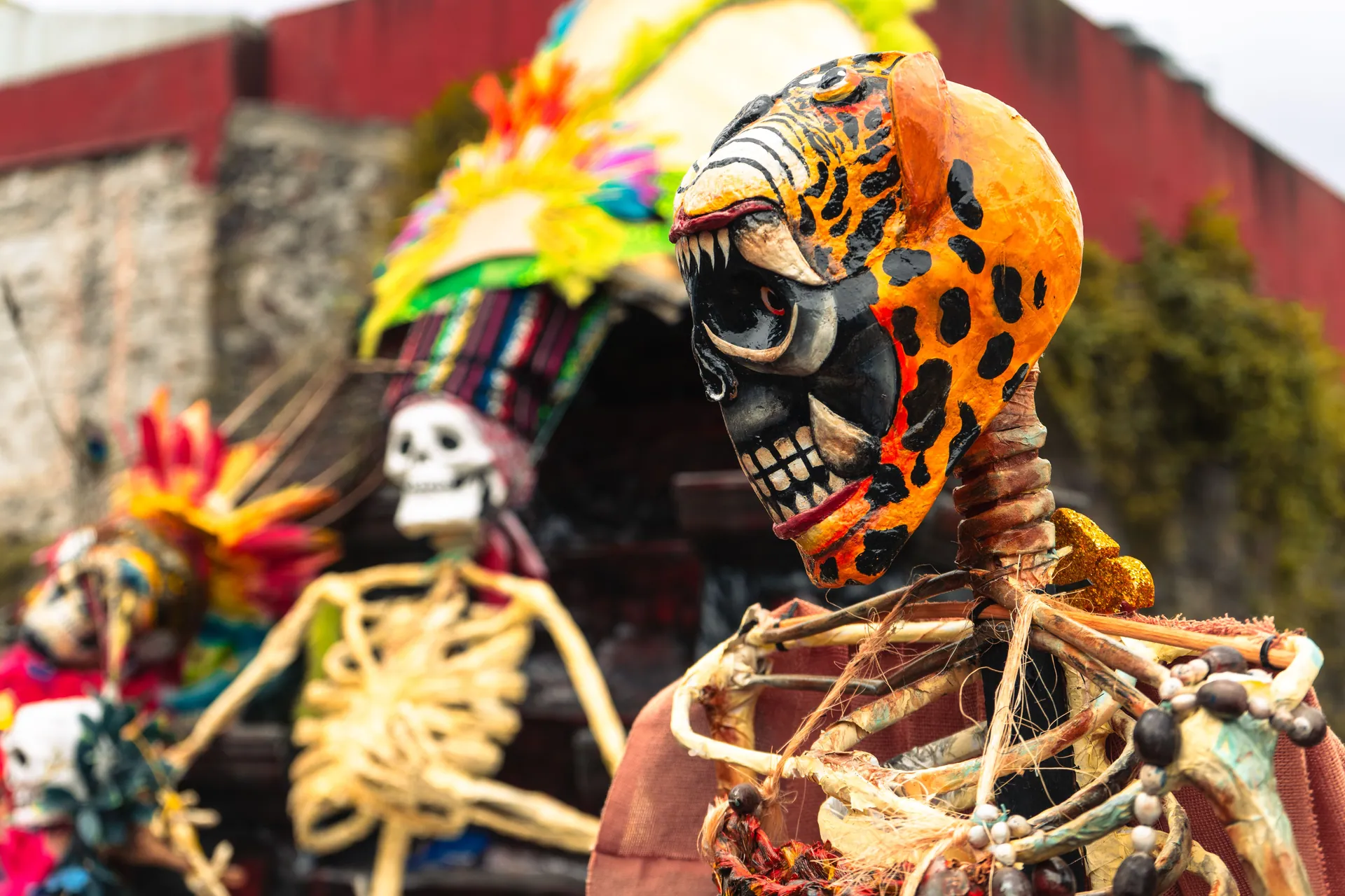 Colorful Dia de los Muertos skeletons display Mexican cultural traditions outdoors.