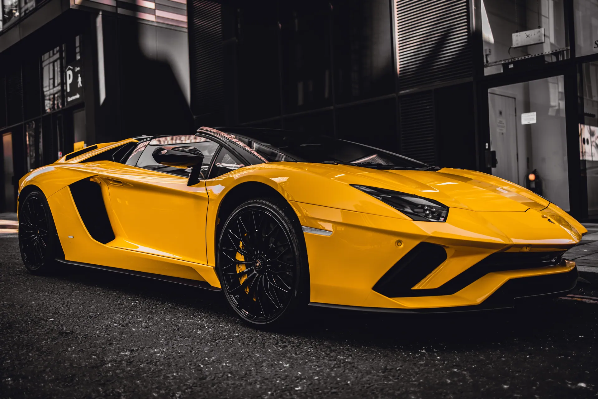 Sleek yellow sports convertible parked in Edinburgh, showcasing luxury and style.