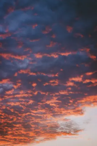 A breathtaking view of a colorful sunset sky in Lagos with vibrant hues and dramatic clouds.