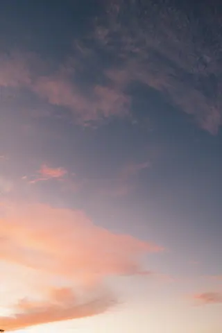 Tranquil sunset scene with pastel clouds and blue sky in Nadi, Fiji.