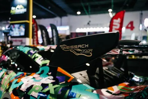 Detailed view of a colorful sports car with custom spoiler at auto show in Pasay City.