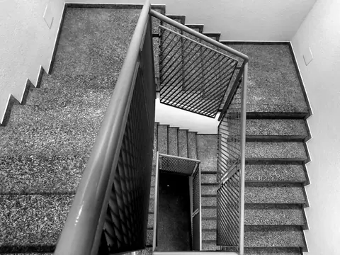 Artistic black and white photo of a multi-level staircase showcasing geometric designs.