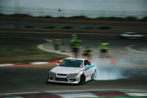 Dynamic drift racing scene captured in Colorado, featuring a Nissan Silvia on a track.