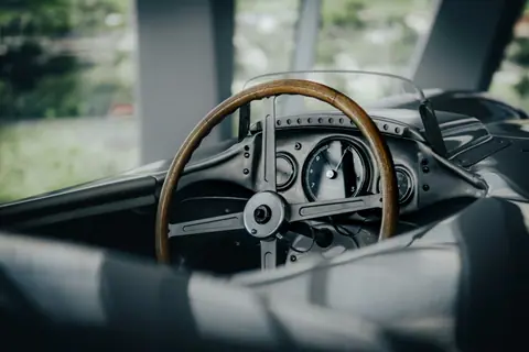 A classic Mercedes-Benz cockpit with wooden steering wheel, showcased in Stuttgart, Germany.