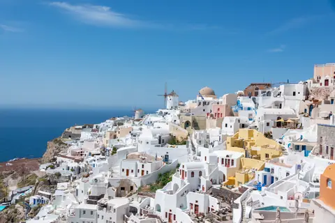 Stunning view of Santorini's iconic architecture and the Aegean Sea under a clear sky.