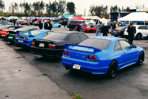 Vibrant car gathering in Ukraine showcasing a variety of colorful vehicles and enthusiasts.