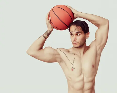 Muscular man posing with a basketball, showcasing strength and focus.