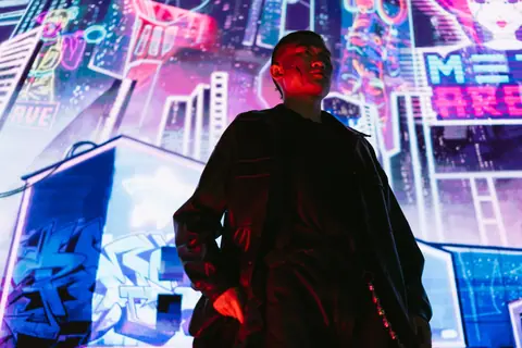A man in a futuristic cyberpunk city with vibrant neon signs and lights.