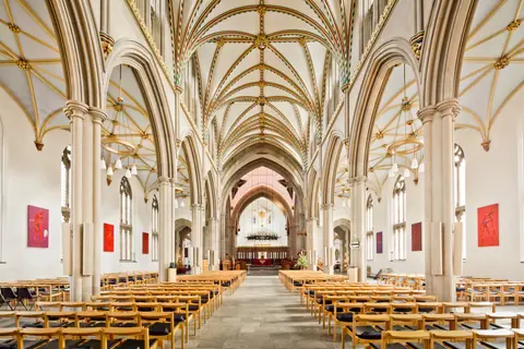 Stunning view of Blackburn Cathedral's gothic interior featuring ornate arches and empty pews.
