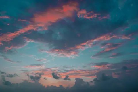 Stunning image capturing the vivid colors of a twilight sky with pink and blue clouds.