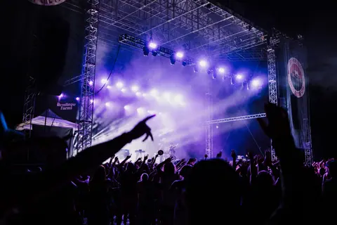A vibrant concert scene in Seattle with an enthusiastic crowd under colorful lights.