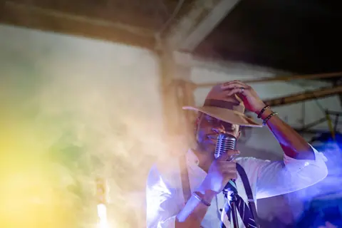 A captivating jazz singer performs with a vintage microphone, creating a moody musical ambience.