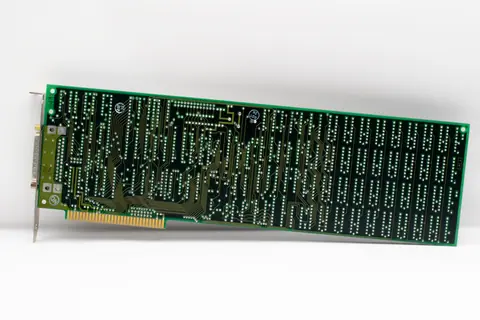 Close-up of a vintage electronic circuit board displaying intricate circuits and components.
