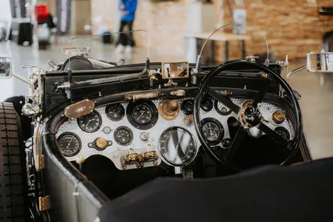 Close-up view of a vintage car's classic dashboard with retro gauges.