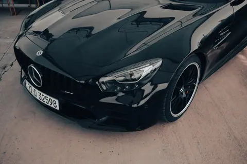 Sleek black Mercedes Benz AMG GT with elegant design and luxury features.