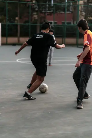 Boys playing a casual soccer game in an Istanbul park, capturing the spirit of outdoor fun.
