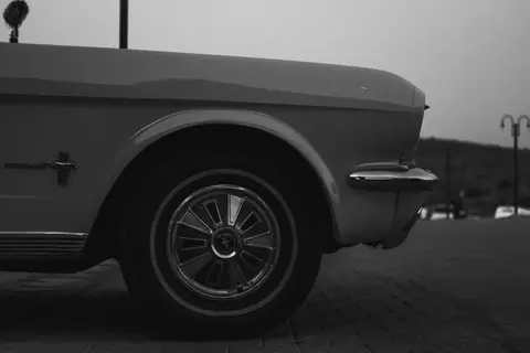 Classic Ford Mustang in vintage monochrome style, showcasing retro automotive design.