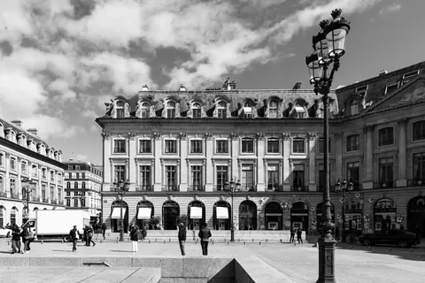 Classic Parisian architecture in black and white at Place Vendôme, showcasing urban elegance and history.