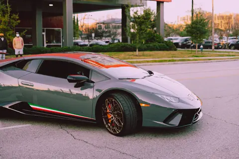 Sleek luxury sports car parked on a city street, showcasing modern design.