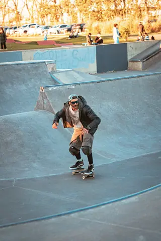 Dynamic shot of a skateboarder in action at a Buenos Aires skatepark during the day.