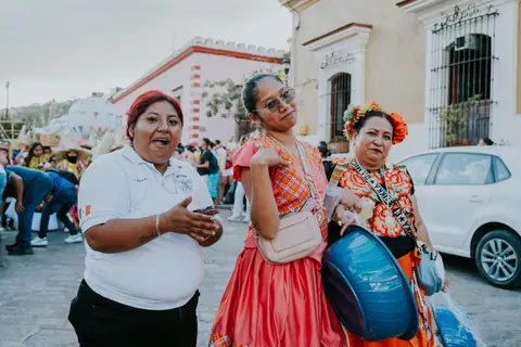 Vibrant cultural celebration on the streets of Oaxaca with traditional clothing and festivities.