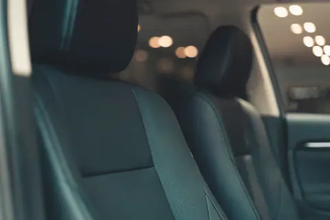 Close-up of a luxury car's leather seats with a soft focus background, showcasing premium comfort