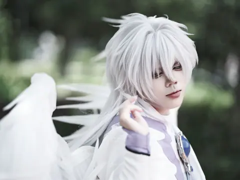A striking fantasy cosplay portrait featuring a character with white hair and costume, shot outdoors.