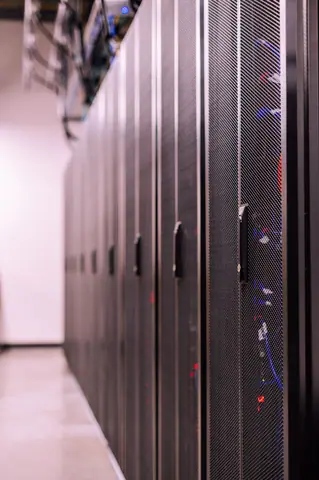 Row of similar lockers with various optic fiber cables in modern data server room