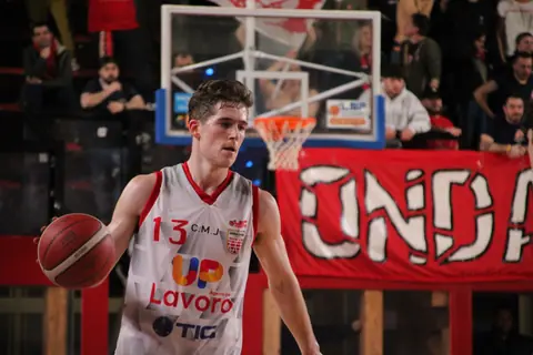 Action-packed basketball game captured in Imola, showcasing a focused player mid-game.