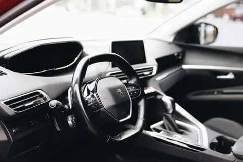 Sleek interior view of a modern car showing steering wheel and dashboard.