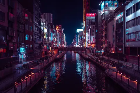 Vibrant night view of Dotonbori Canal in Osaka, Japan, showcasing illuminated city lights.