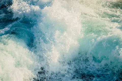 Close-up view of powerful ocean waves crashing, capturing the natural beauty and energy of the sea.