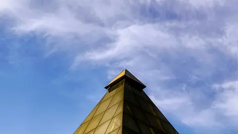 Golden Tower Reaching Into a Blue Sky - backiee