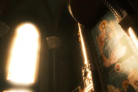 A sunlit church interior highlighting religious art and iconography.