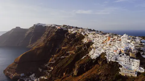 A stunning aerial view of Fira's iconic white buildings on Santorini's cliffs.