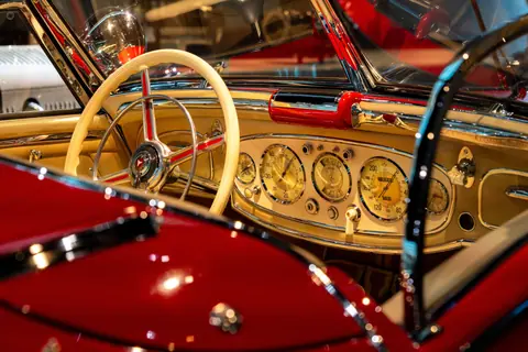 Detailed view of a vintage convertible's dashboard with classic gauges and elegant design.