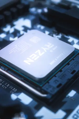Detailed close-up of a Ryzen CPU installed on a motherboard, emphasizing technology and hardware.