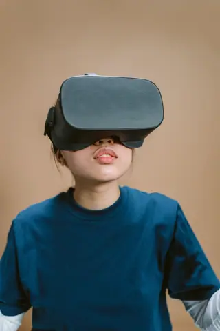 Portrait of a woman enjoying a virtual reality experience indoors.
