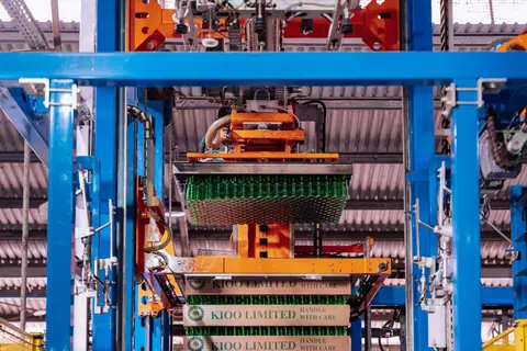 Glass manufacturing process at a factory in Dar es Salaam, showcasing automated machinery.