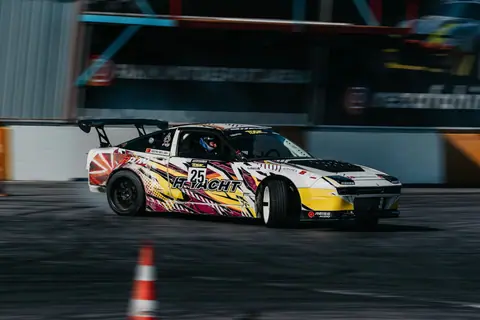 Dynamic shot of a racing car drifting on a track during daylight in Istanbul, Turkey.