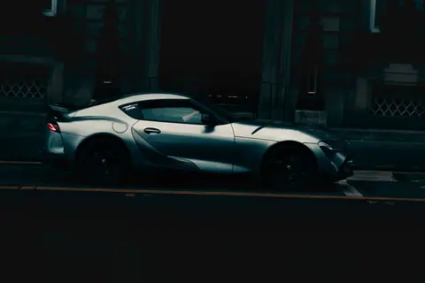 Moody photo of a sleek sports car parked on a dimly lit street in Edinburgh, Scotland.