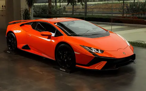 Stunning orange Lamborghini Huracan sports car displayed indoors, showcasing luxury and style.