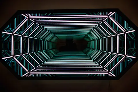 An abstract view inside a neon-lit tunnel creating a futuristic effect with vibrant colors.
