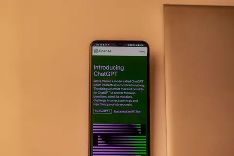 A smartphone showing the ChatGPT interface, emphasizing technology and AI indoors.