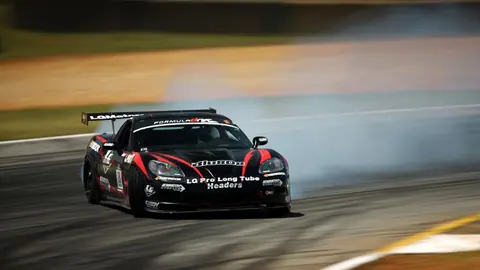 Black Chevrolet Corvette C6 Racing Through a High Speed Drift - backiee