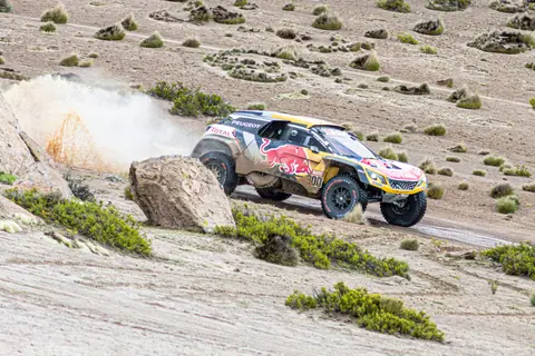 Dynamic off-road race car kicking up dust in the desert near Arequipa, Peru.
