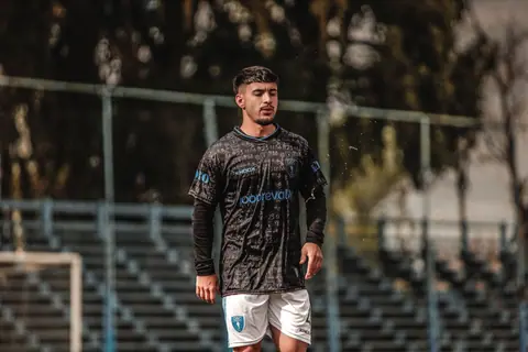 A young male soccer player in athletic attire during an outdoor training session.